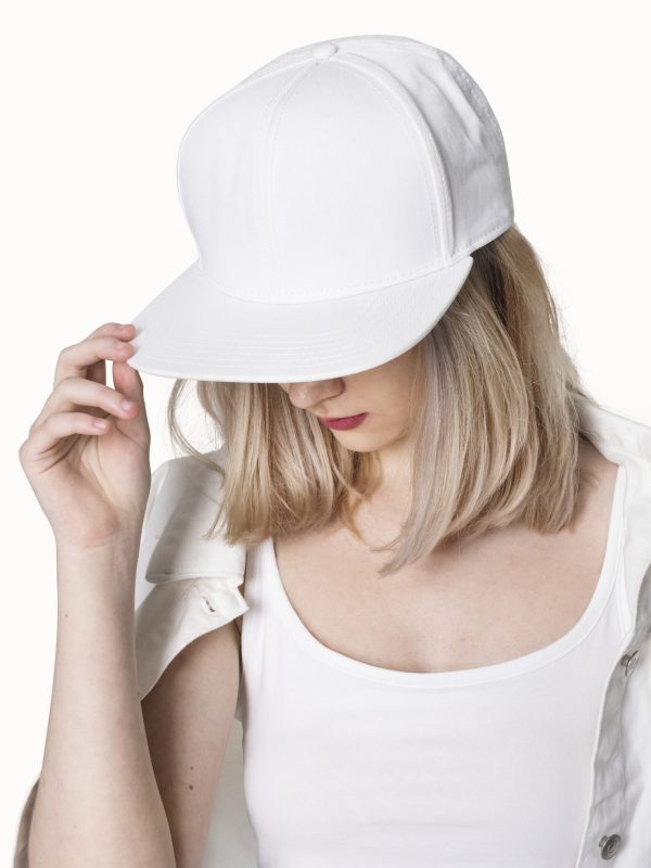 Teenage girl in white snapback cap street fashion shoot